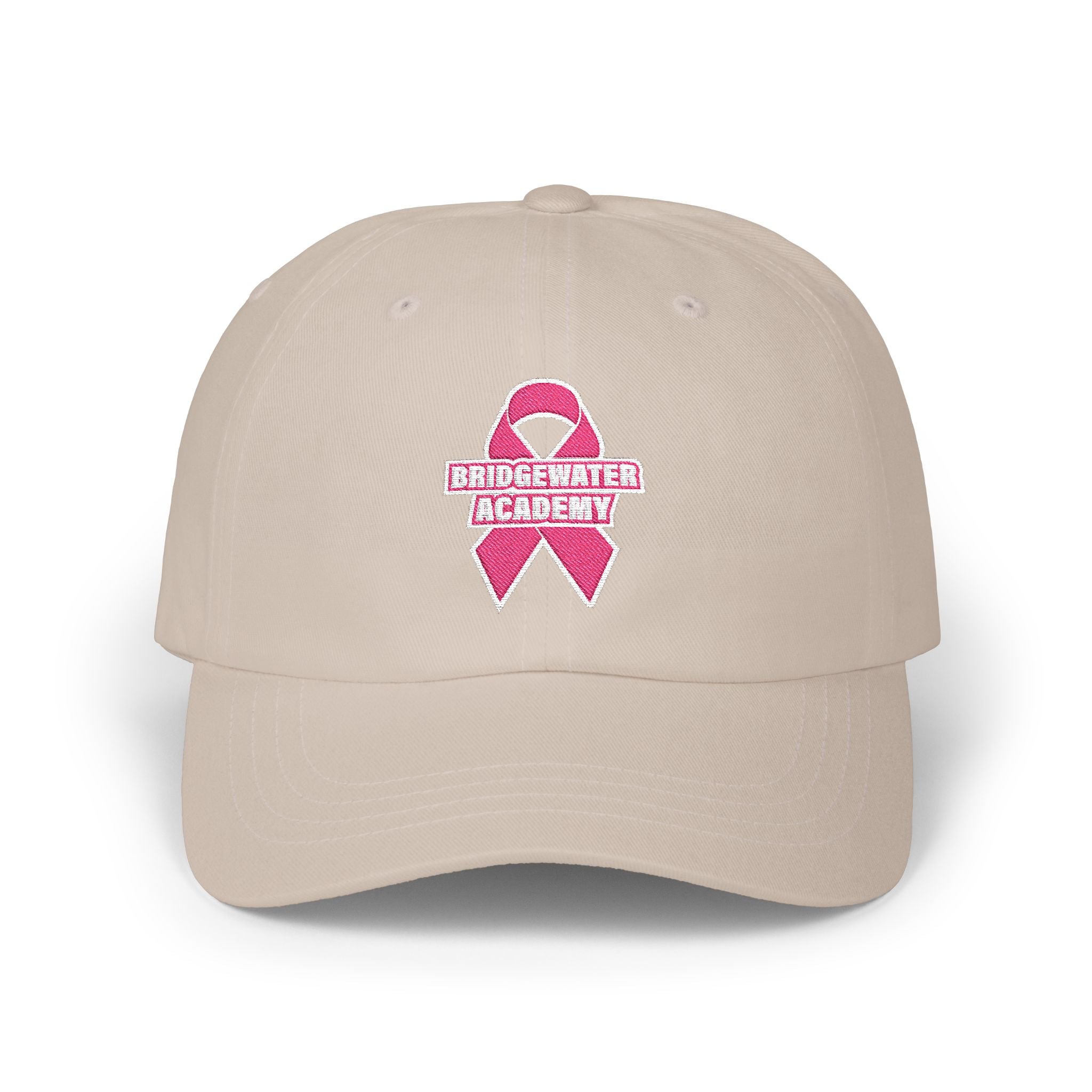 Beige cap with pink breast cancer awareness ribbon and 'Bridgewater Academy' text on a white background