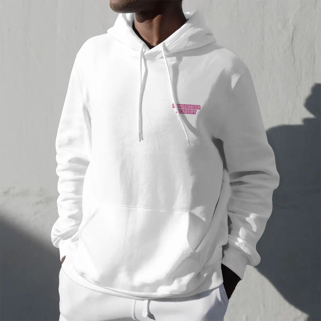 White hoodie with a pink logo worn by a person against a light gray background